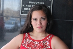 Mia's Senior Photos against the black tile of Temple Theatre.